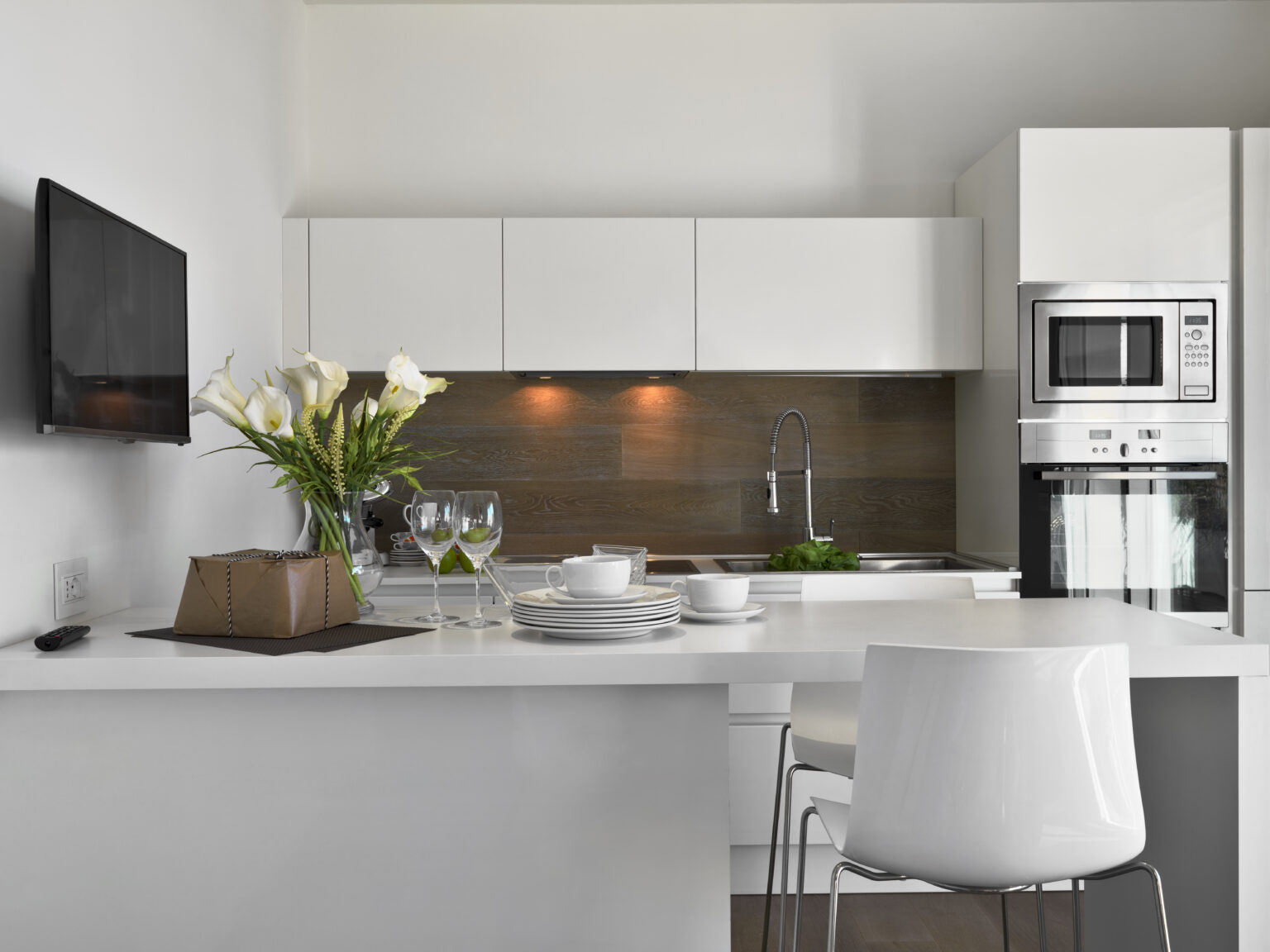 interior shots of a modern white kitchen and kitchen island