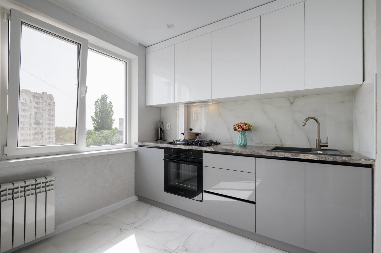 Interior of white and grey small modern domestic kitchen furniture