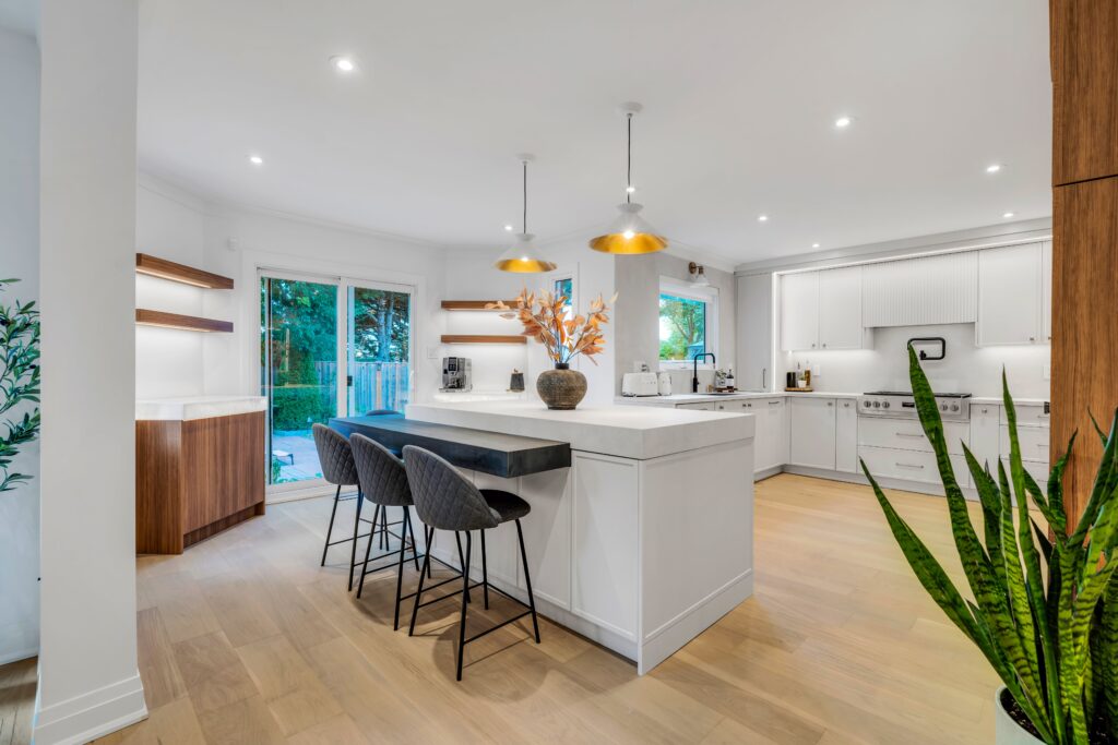 Modern kitchen renovation with large island, pendant lighting, and open-concept layout