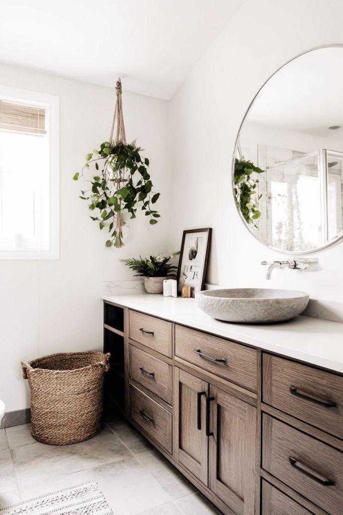 Bohemian bathroom renovation ideas in Toronto with wood vanity, vessel sink, hanging plants, and natural textures for a warm and relaxed design.