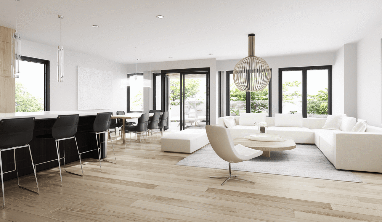 Modern basement renovation in Toronto featuring an open-concept layout, light wood flooring, minimalist furniture, and large windows for a bright and airy space.