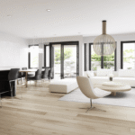 Modern basement renovation in Toronto featuring an open-concept layout, light wood flooring, minimalist furniture, and large windows for a bright and airy space.