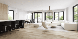 Modern basement renovation in Toronto featuring an open-concept layout, light wood flooring, minimalist furniture, and large windows for a bright and airy space.