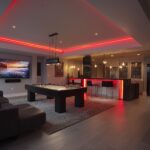 Basement finishing Toronto entertainment room with bar area, pool table, LED lighting and modern open layout