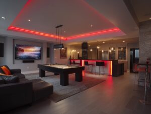 Basement finishing Toronto entertainment room with bar area, pool table, LED lighting and modern open layout