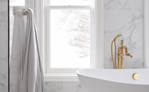 Bathroom renovation Toronto with white marble walls, freestanding bathtub and gold fixtures modern luxury design