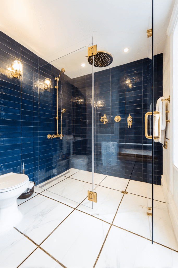 Modern walk-in shower bathroom renovation Toronto DIY with blue tiles and gold fixtures